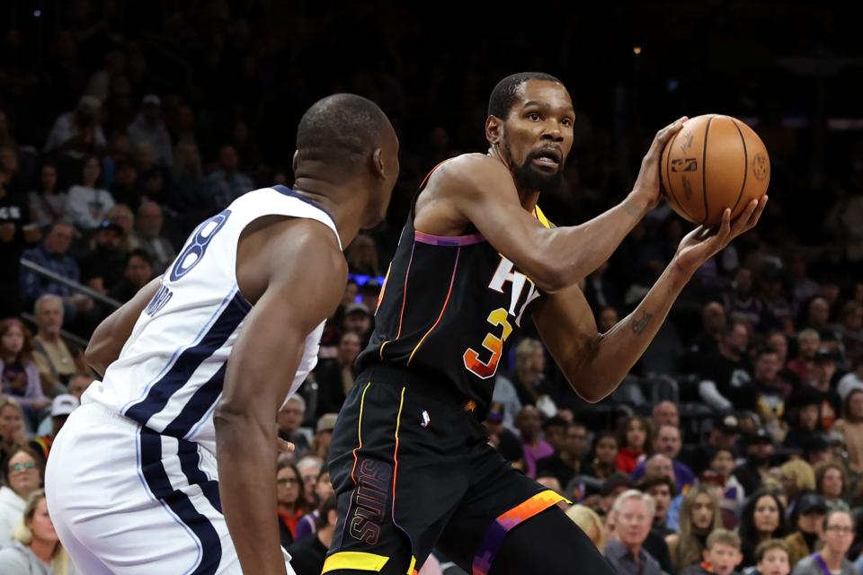 Kevin Durant #35 of the Phoenix Suns makes a pass against Bismack Biyombo #18 of the Memphis Grizzlies at Footprint Center on Dec. 2, 2023 in Phoenix. NOTE TO USER: User expressly acknowledges and agrees that, by downloading and/or using this photograph, User is consenting to the terms and conditions of the Getty Images License Agreement. (Photo by Zac BonDurant/Getty Images)