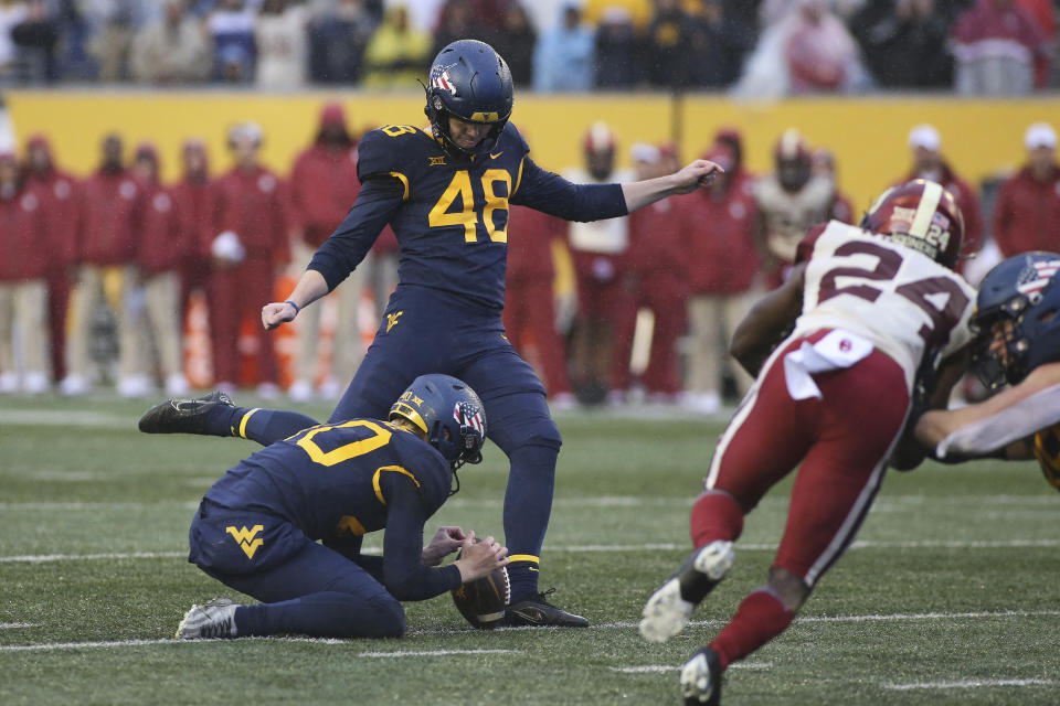 West Virginia place kicker Casey Legg kicks the game winning field goal during the second half of an NCAA college football game against Oklahoma in Morgantown, W.Va., Saturday, Nov. 12, 2022. (AP Photo/Kathleen Batten)