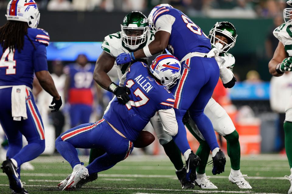 Buffalo Bills quarterback Josh Allen (17) fumbles the ball as he is hit by New York Jets defensive end Micheal Clemons (72) during the fourth quarter of an NFL football game, Monday, Sept. 11, 2023, in East Rutherford, N.J. (AP Photo/Adam Hunger)