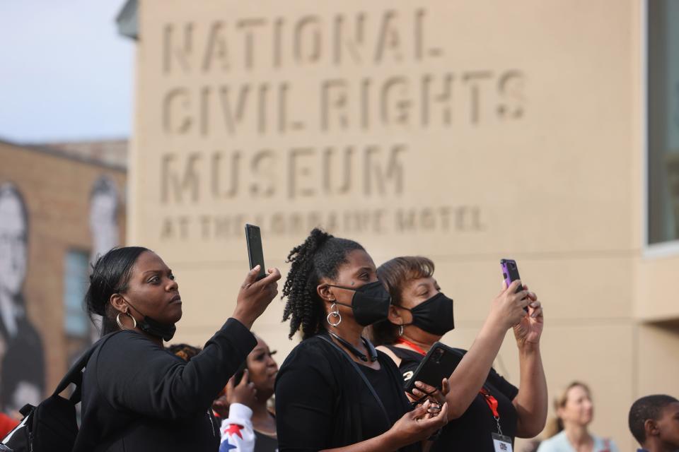 People gather at the National Civil Rights Museum, at the site of the Lorraine Motel where Martin Luther King, Jr. was assassinated in 1968, to honor the civil rights leader on the 54th anniversary of his death Monday, April 4, 2022.