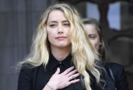 American actress Amber Heard, former wife of actor Johnny Depp, gestures as she gives a statement after the end of the trial outside the High Court in London, Tuesday, July 28, 2020. Hollywood actor Johnny Depp is suing News Group Newspapers over a story about his former wife Amber Heard, published in The Sun in 2018 which branded him a 'wife beater', a claim he denies. (AP Photo/Alberto Pezzali)