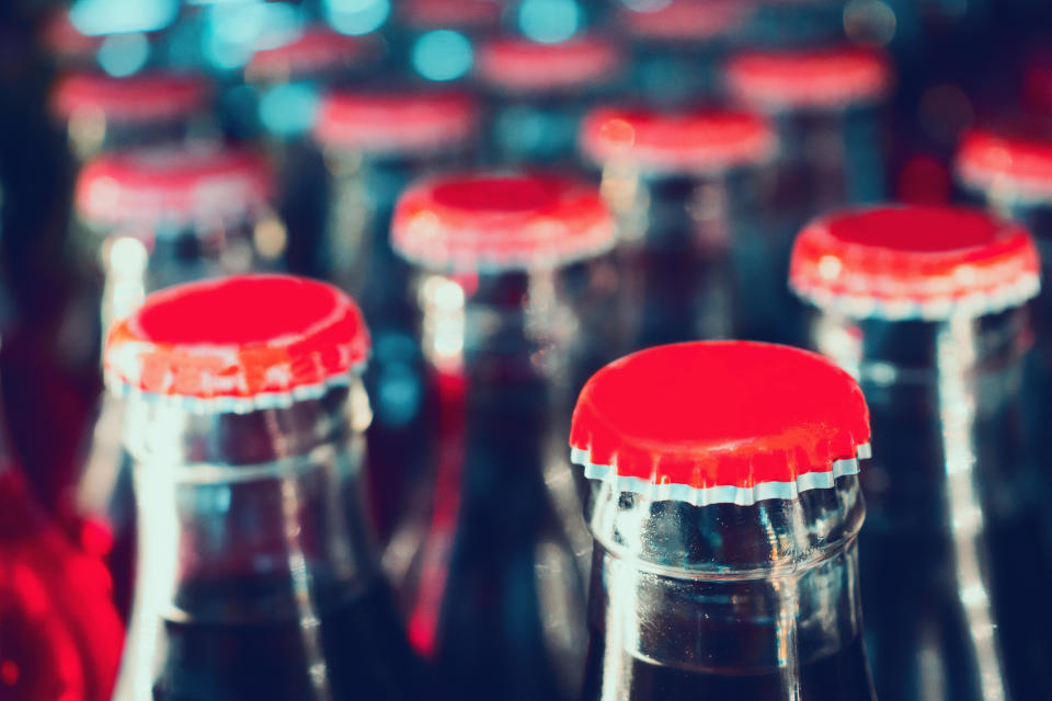 Close-up of numerous glass soda bottles.