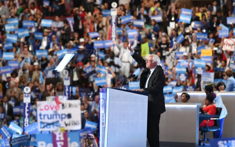 Former presidential candidate Bernie Sanders tells delegates at the Democratic National Convention in Philadelphia that Hillary Clinton must become president