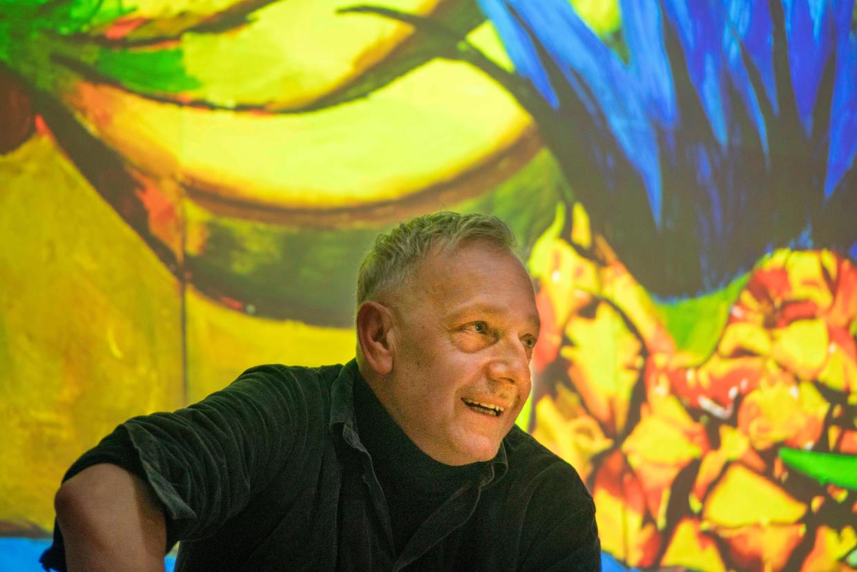 Italian artist Andrea Ventura watches as his works are hung on the walls of Indiana University's Grunwald Gallery of Art.