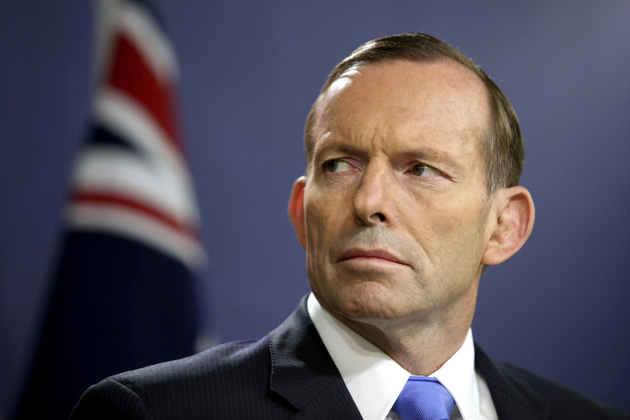 FILE - In this Sept. 19, 2014, file photo, former Australian Prime Minister Tony Abbott speaks during a press conference, in Sydney. Abbott has claimed the “top levels” of the Malaysian government long suspected the vanishing of a plane almost six years ago was a mass murder-suicide by the pilot. (AP Photo/Rick Rycroft, File)