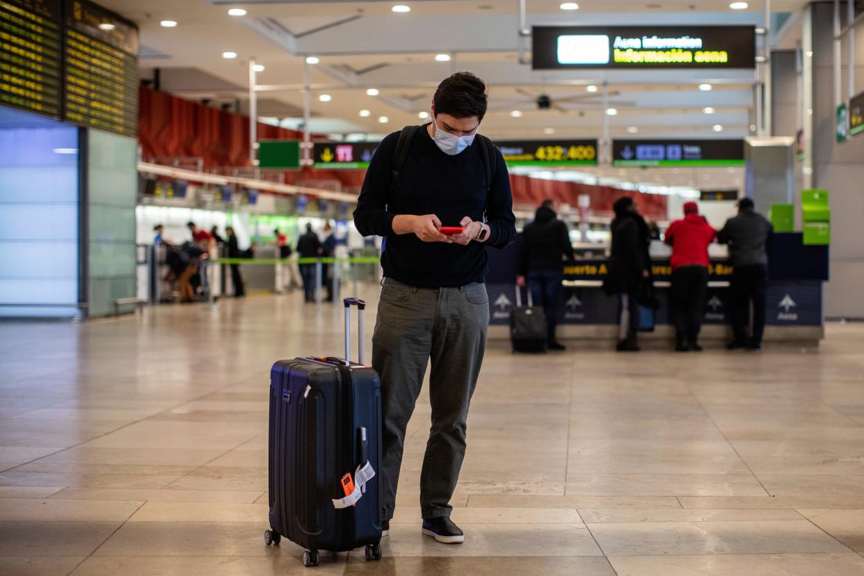 A passenger wears a protective mask at Adolfo Suarez-Barajas international airport on the outskirts of Madrid, Spain, Wednesday, March 11, 2020. Spanish authorities closed schools and halted direct flights to and from Italy. Italy is the country with most coronavirus cases in Europe, and Spain this week reported a sharp increase in cases. For most people, the new coronavirus causes only mild or moderate symptoms, such as fever and cough. For some, especially older adults and people with existing health problems, it can cause more severe illness, including pneumonia. (AP Photo/Bernat Armangue)