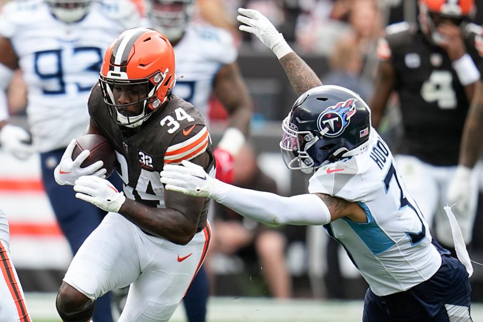 Browns running back Jerome Ford runs past Tennessee Titans safety Amani Hooker, right, during the first half, Sunday, Sept. 24, 2023, in Cleveland.