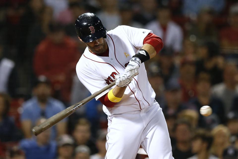 FILE - In this Sept. 7, 2019, file photo, Boston Red Sox's J.D. Martinez hits a solo home run during the ninth inning of a baseball game against the New York Yankees in Boston. Red Sox designated hitter Martinez has decided to keep his contract with the team instead of becoming a free agent again. (AP Photo/Michael Dwyer, File)