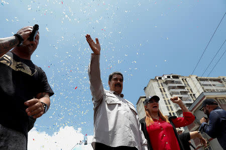 Venezuela's President Nicolas Maduro greets supporters next to his wife Cilia Flores during a campaign rally in Charallave, Venezuela May 15, 2018. REUTERS/Carlos Garcia Rawlins