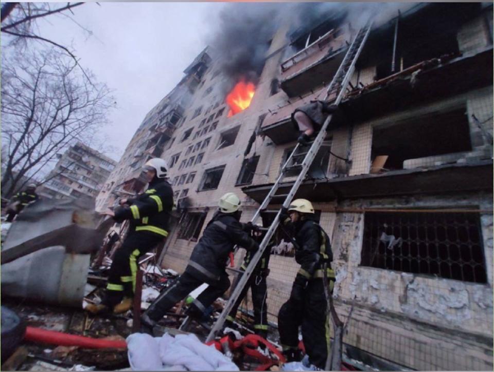 Firefighters work on a hit building