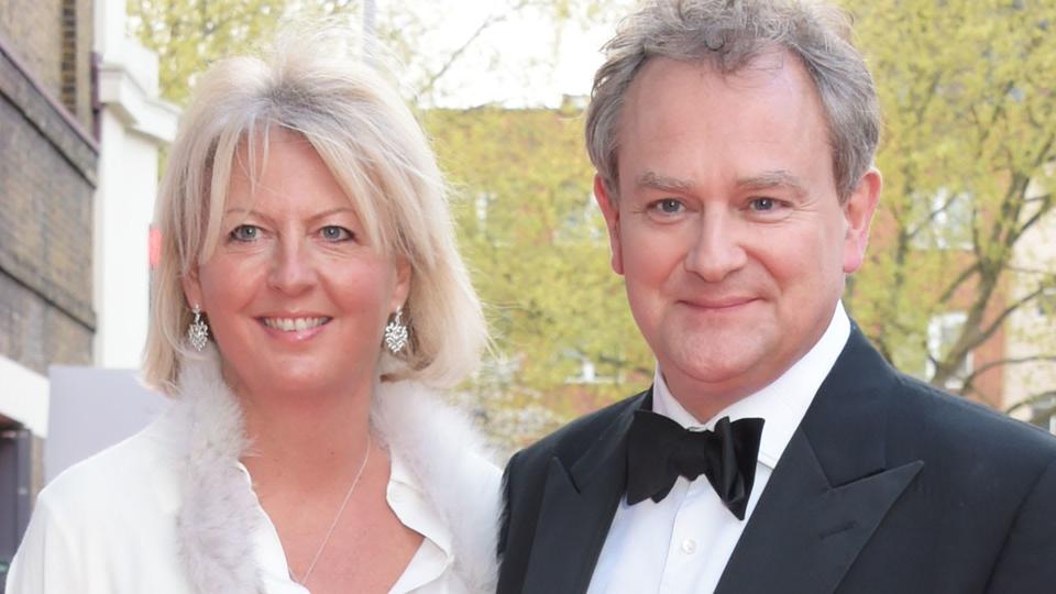 Lulu Williams in silk trousers and Hugh Bonneville in a suit on the red carpet