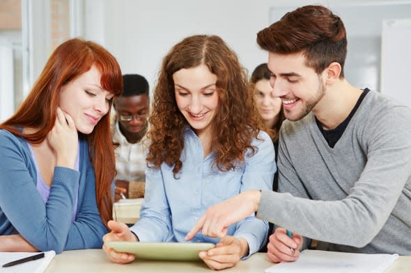 three happy students learning...