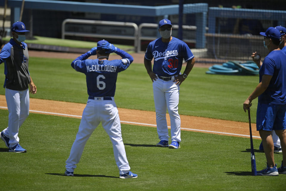 Los Angeles Dodgers manager Dave Roberts (30) talks with members of the team during the restart of spring training Friday, July 3, 2020, in Los Angeles. (AP Photo/Mark J. Terrill)