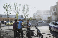 Police officers stop and search a motorbike driver and his passenger who did not wear any helmets, in the Paris suburb of Villiers-le-Bel on Tuesday, June, 15, 2021. (AP Photo/Lewis Joly)