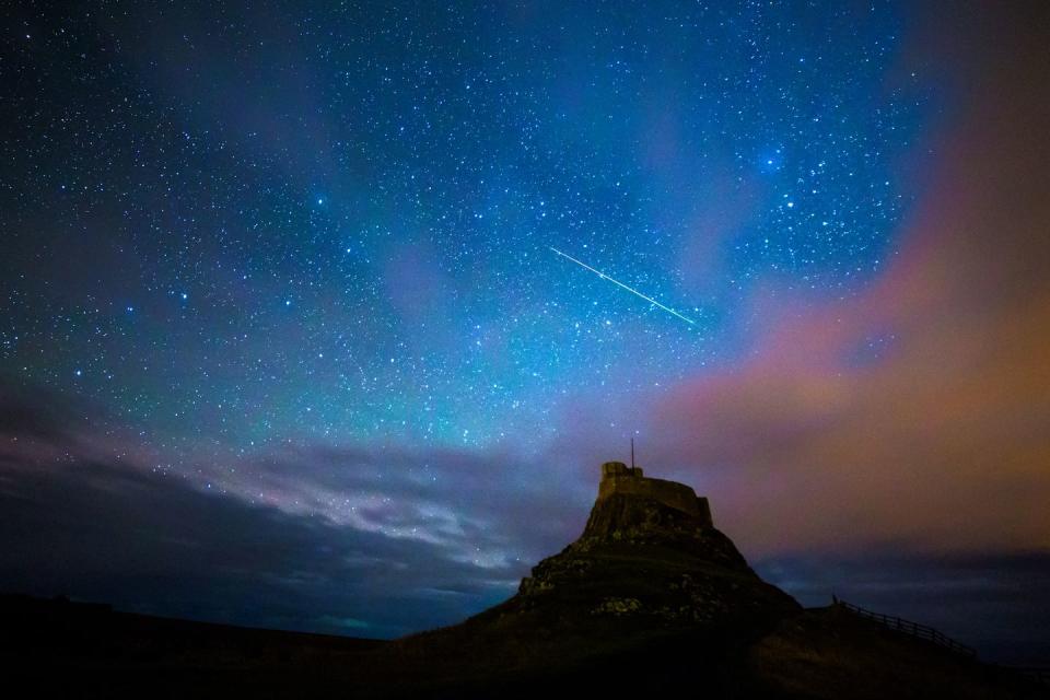 geminid meteor over lindisfarne castle on the holy island, nothumberland