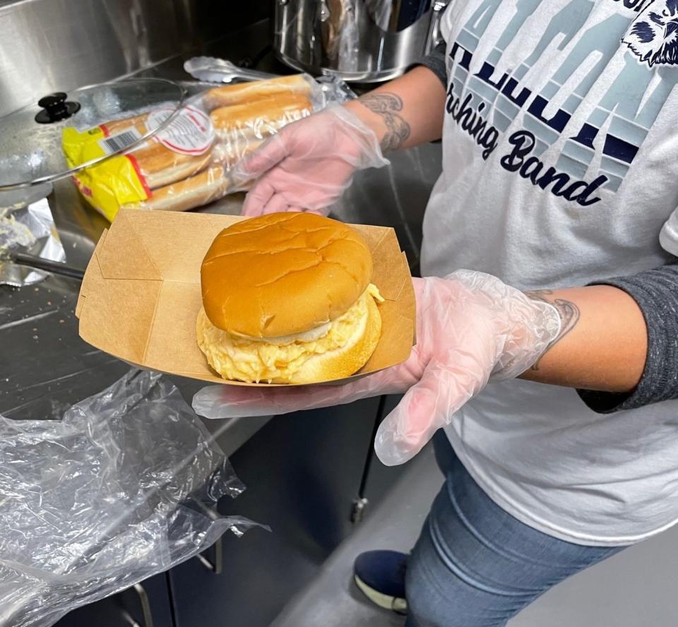 Melissa Stotzer prepares a cream chicken sandwich inside the Fairless High concession stand.