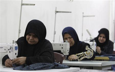 Widows work on sewing machines at a widows' training and development centre in Baghdad in this November 13, 2012 file photo. REUTERS/Saad Shalash/Files