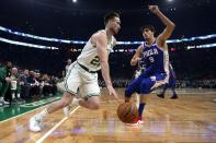 Boston Celtics' Gordon Hayward (20) drives past Philadelphia 76ers' Dario Saric (9) during the first half of an NBA basketball game in Boston, Tuesday, Oct 16, 2018. (AP Photo/Michael Dwyer)