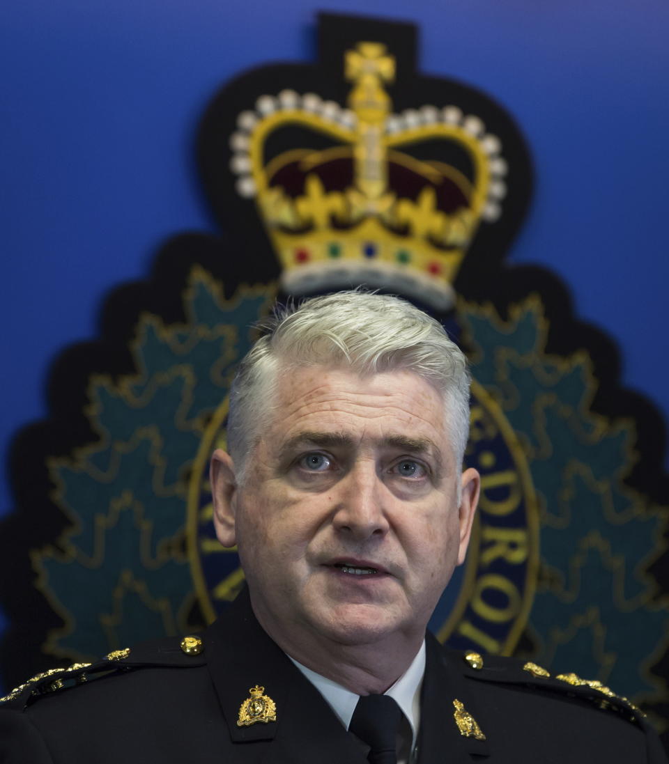 Royal Mounted Police Assistant Commissioner Kevin Hackett pauses while speaking during a news conference in Surrey, British Columbia, Tuesday, July 23, 2019. Two young men thought missing are now suspects in the murders of an American woman and her Australian boyfriend as well as the death of another man in northern British Columbia, Canadian police said Tuesday. (Darryl Dyck/The Canadian Press via AP)