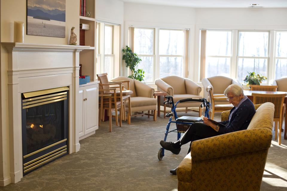 Wake Robin Assisted Living resident C. Shirley Brevda, reads a book in a living room area that overlooks Lake Champlain. Dr. Stephen Leffler, president and chief operating officer of the UVM Medical Center, says Vermont is short at least 500 beds for long-term care.
