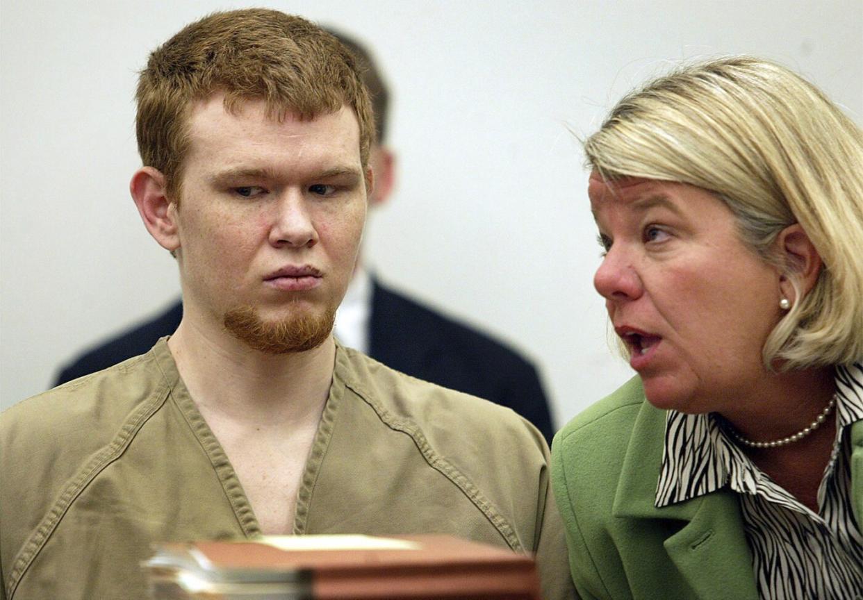 Johnny Johnson, left, listens as his attorney Bevy Beimdiek speaks during his sentencing hearing in St. Louis County Court in Clayton, Mo., March 7, 2005. (Gabriel B. Tait/St. Louis Post-Dispatch via AP)