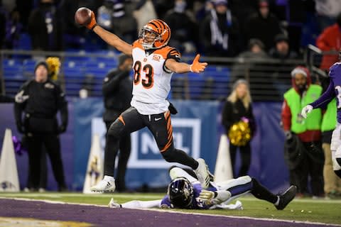 Cincinnati Bengals wide receiver Tyler Boyd (83) reacts as he scores the winning touchdown as Baltimore Ravens cornerback Brandon Carr (24) lies on the ground during the second half of an NFL football game in Baltimore. The Bengals return Sunday to the place where they broke the Ravens' hearts and made the Buffalo Bills giddy with one big play in the final regular season game last season - Credit: AP Photo/Nick Wass