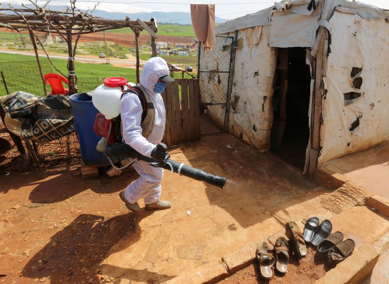 FILE PHOTO: A worker from the municipality sanitizes Syrian refugee camp, as Lebanon extends a lockdown by two weeks to combat the spread of coronavirus disease (COVID-19) in Marjayoun