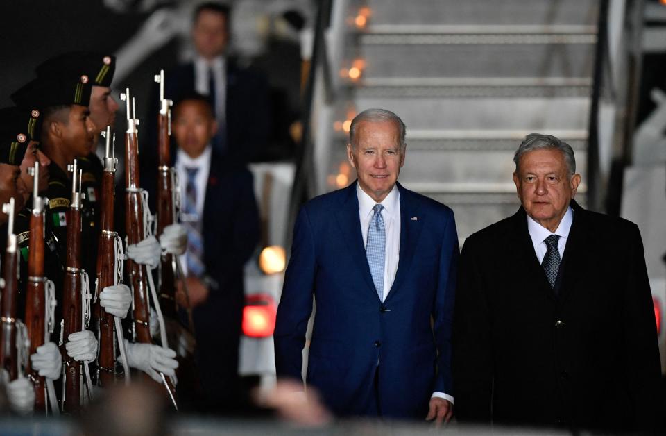 US President Joe Biden (L) is welcomed by his Mexican counterpart Andres Manuel Lopez Obrador upon landing at Felipe Angeles International Airport in Zumpango de Ocampo, north of Mexico City on January 8, 2023.