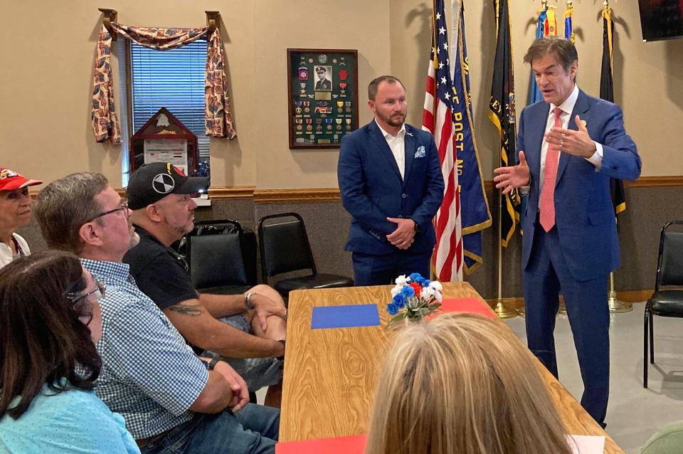 Republican U.S. Senate nominee Dr. Mehmet Oz, far right, talks to residents at the American Legion Post 571 in Wesleyville on Aug. 8, 2022. To Oz's right, at center, is Erie County Executive Brenton Davis.