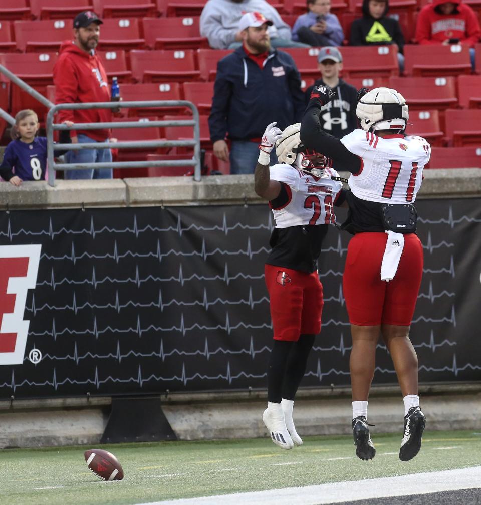 Louisville’s Maurice Turner and Jamari Johnson celebrate after Turner ran for a touchdown against the Cardinals' defense in April 2023.