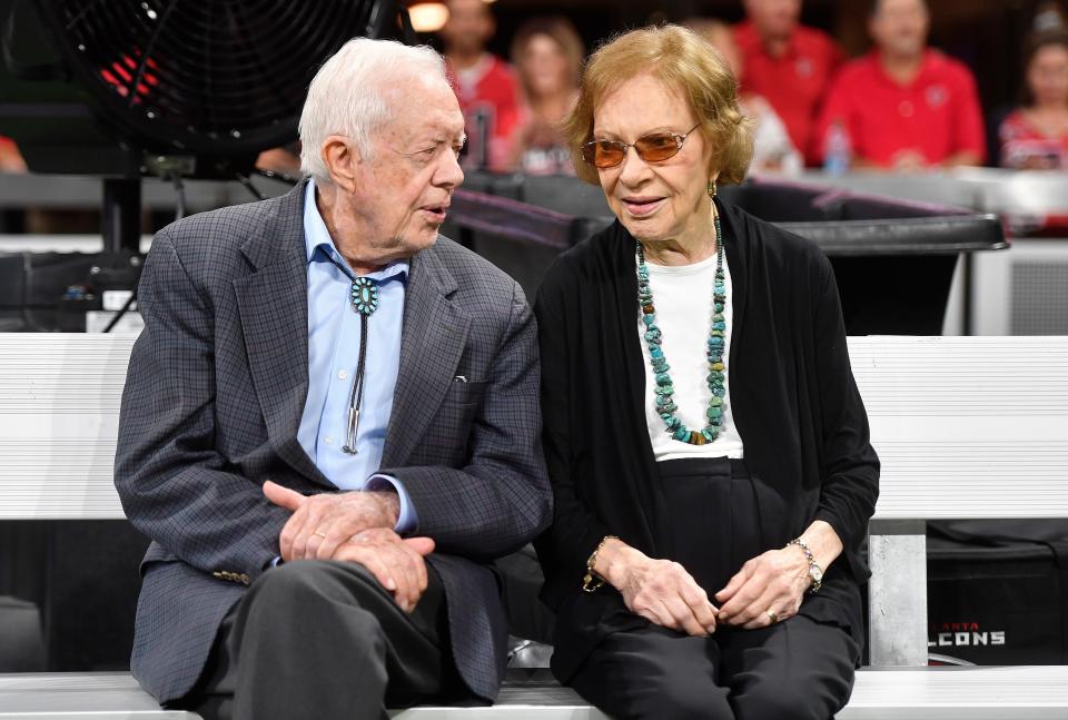Former President Jimmy Carter, left, and former first lady Rosalynn Carter, sit together at an NFL game between the Atlanta Falcons and the Cincinnati Bengals on Sept. 30, 2018, in Atlanta.