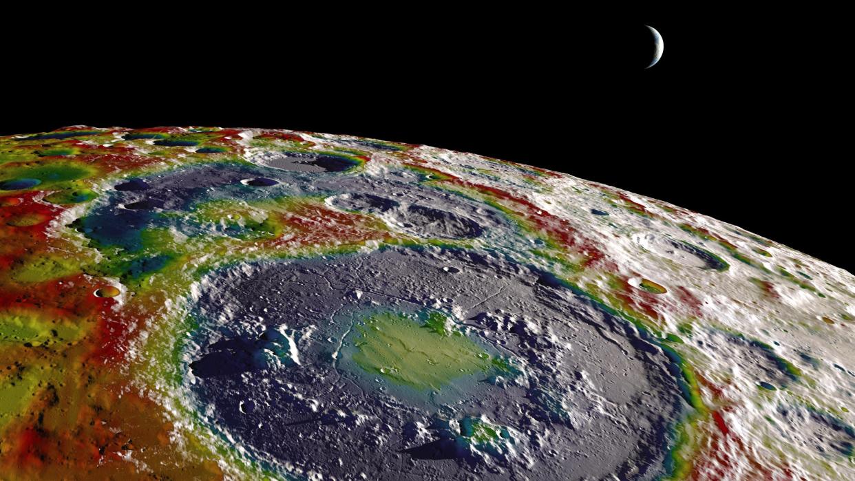  A false color image of the lunar south pole, showing areas of lower gravity in purple and higher gravity in red. 