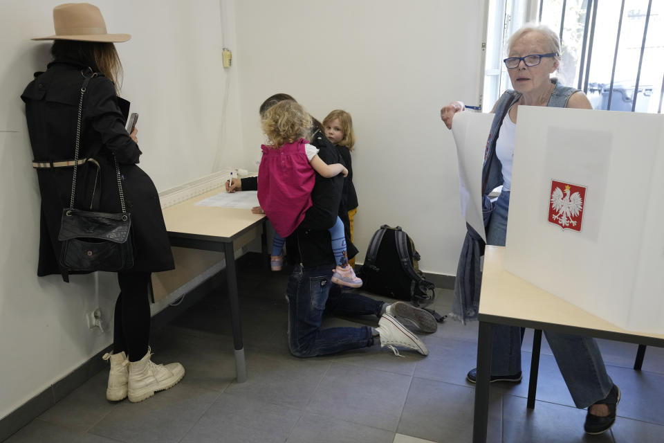 People vote during local elections in Warsaw, Poland, Sunday, April 7, 2024. Voters across Poland are casting ballots in local elections Sunday in the first electoral test for the coalition government of Prime Minister Donald Tusk nearly four months since it took power. (AP Photo/Czarek Sokolowski)