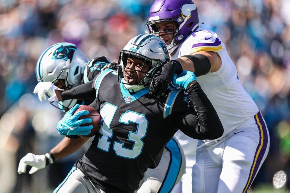 Panthers outside linebacker Haason Reddick, center, pushes away Vikings defender as he runs with the ball after intercepted during the game at Bank of America Stadium on Sunday, October 17, 2021 in Charlotte, NC.