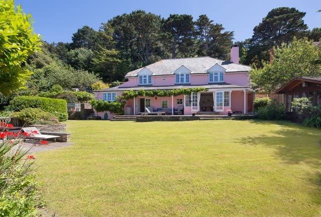 This stunning pink house comes with its own beach. (SWNS)