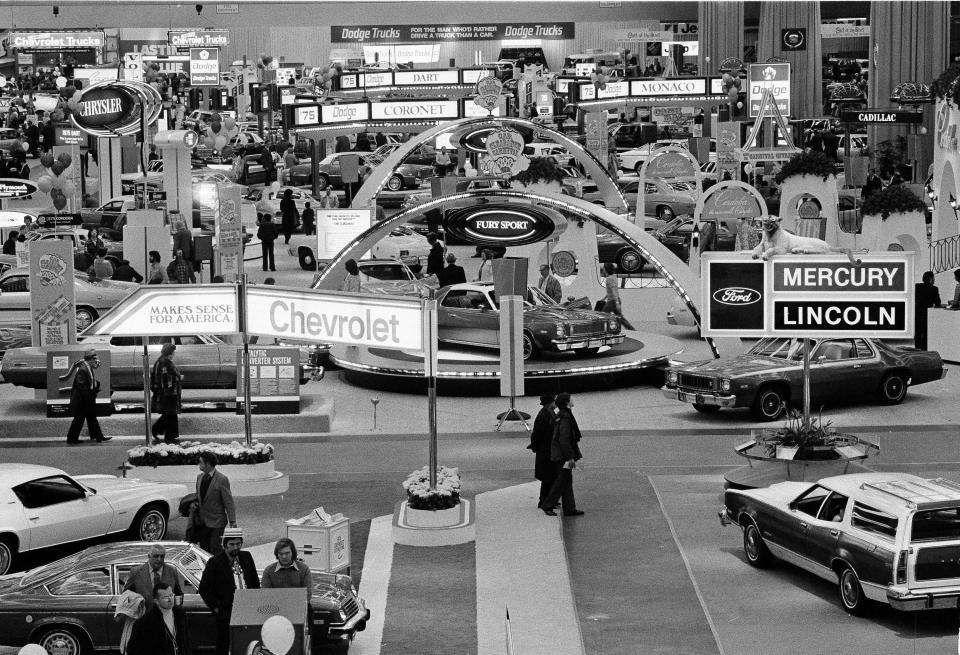 FILE - In this Jan. 15, 1975 file photo, crowds visit the 59th Detroit Auto Show in the Cobo Arena in Detroit. Hundreds of thousands of buyers and car fans are expected to crowd Detroit’s North American International Auto Show in 2014. (AP Photo/File)