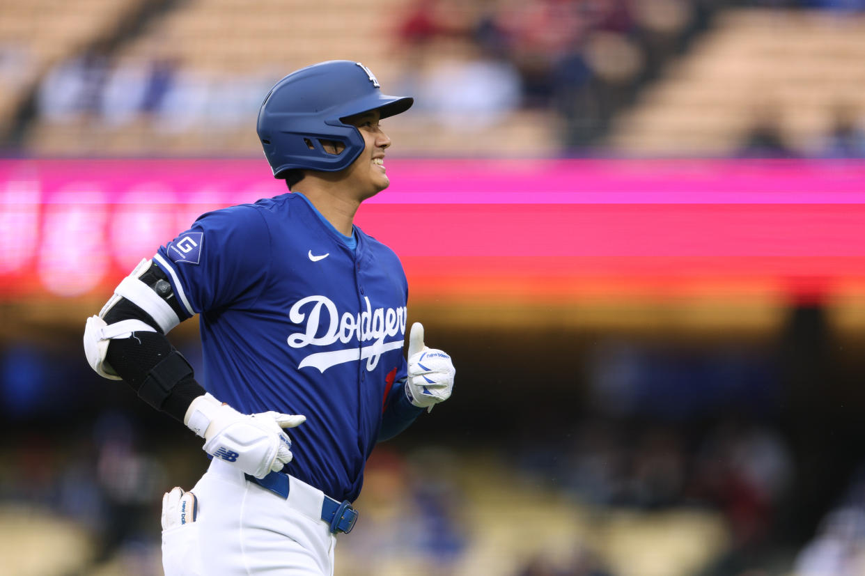 LOS ANGELES, CALIFORNIA - MARCH 24: Shohei Ohtani #17 of the Los Angeles Dodgers smiles as he jogs back to the dugout during a preseason game against the Los Angeles Angels at Dodger Stadium on March 24, 2024 in Los Angeles, California. (Photo by Harry How/Getty Images)