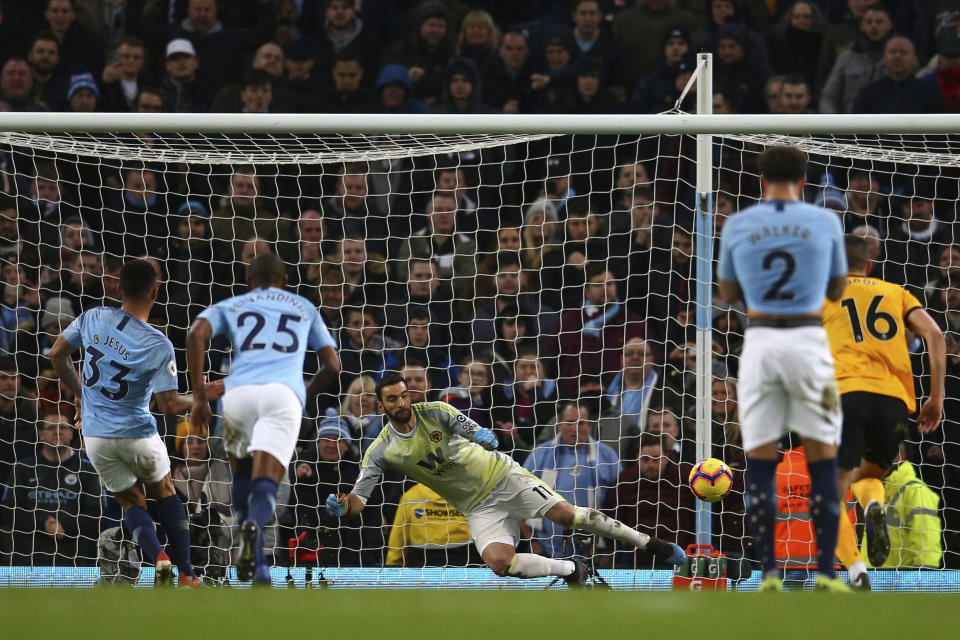 Manchester City's Gabriel Jesus, left, scores with penalty against Wolverhampton Wanderers during the English Premier League soccer match between Manchester City and Wolverhampton Wanderers at the Etihad Stadium in Manchester, England, Monday, Jan. 14, 2019. (AP Photo/Dave Thompson)