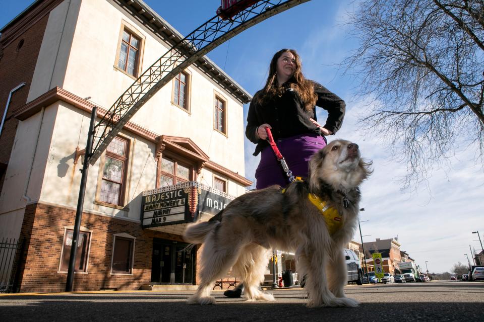 Jessica Griesheimer, of Chillicothe, stands in front of the Majestic Theater with her 11 year-old mixed breed dog "Stormagheddon" on Feb. 16, 2024, in Chillicothe, Ohio. Jessica is making a feature length film called "Without Her" which is about domestic violence from a dogs perspective. Jessica she is anticipating the film will be premeiring at the Majestic Theater in October 2024.