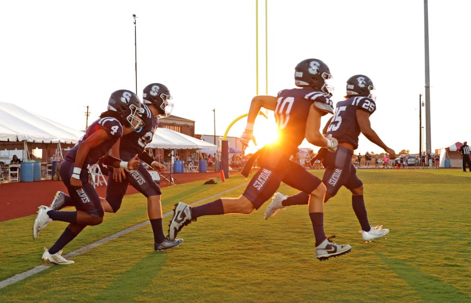 Shawnee football players take the field before a high school football game against Carl Albert on Sept. 28 at Crain Family Stadium on the Oklahoma Baptist University campus in Shawnee.