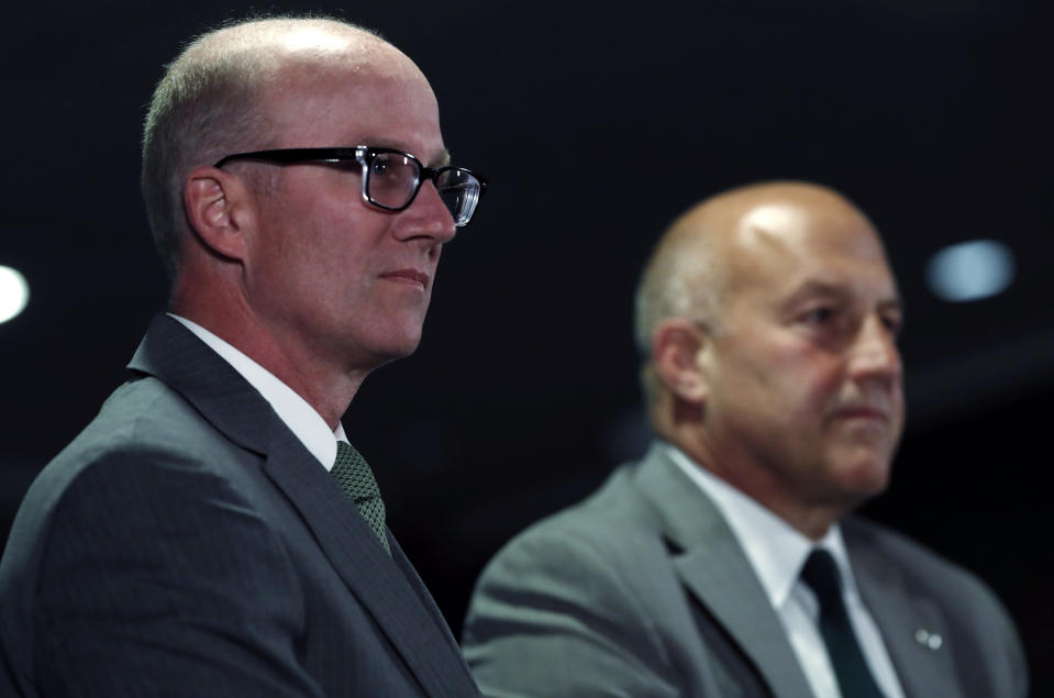 Joe Parker, left, athletic director at Colorado State University, considers a question as Steve Addazio looks on during an announcement that Addazio has been hired as the new head football coach at the school at a news conference Thursday, Dec. 12, 2019, in Fort Collins, Colo. (AP Photo/David Zalubowski)