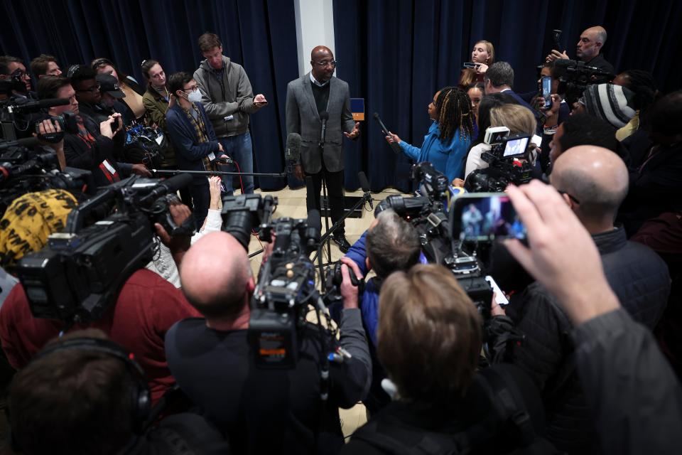 Georgia Democratic Senate candidate Raphael Warnock  answers questions from reporters after speaking at a Students for Warnock rally at Georgia Tech, 5 December 2022 in Atlanta, Georgia (Getty Images)