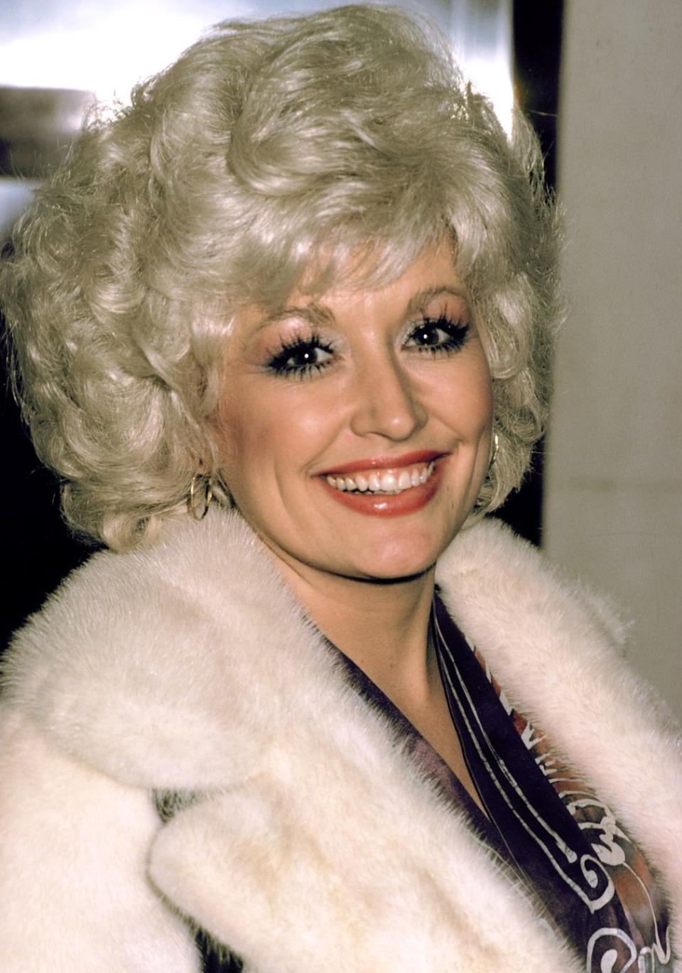 <p> Dolly looks cozy and chic in a fur coat at a premiere in Edinburgh, Scotland. The singer is most-always found in voluptuous makeup and hoop earrings.</p>