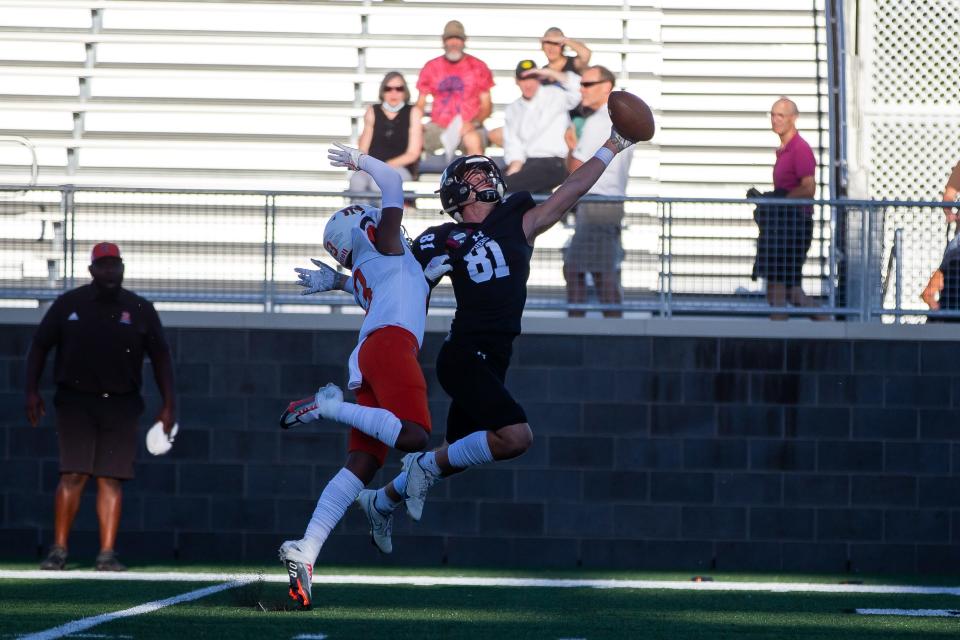 West Ottawa's Evan Janetzke reaches for the ball as it sails overhead Thursday, Sept. 1, 2022, at West Ottawa Stadium. 