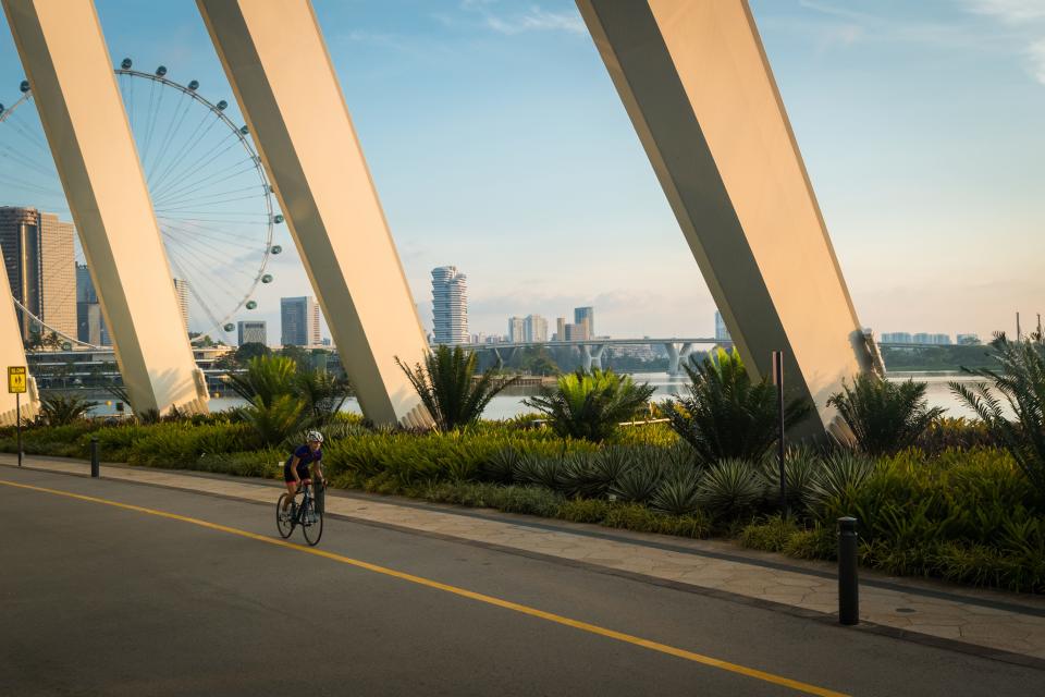 A lone cyclist riding his bike along a path at the Gardens by The Bay in Singapore.