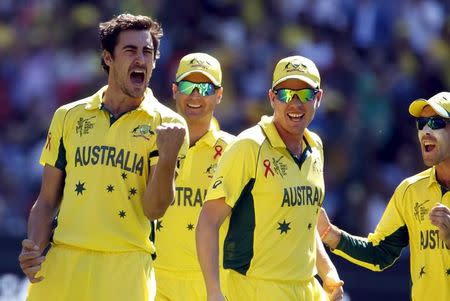 Australia's Mitchell Starc (L) celebrates with team mates after bowling New Zealand's captain Brendon McCullum for a duck during their Cricket World Cup final match at the Melbourne Cricket Ground (MCG) March 29, 2015. REUTERS/Brandon Malone