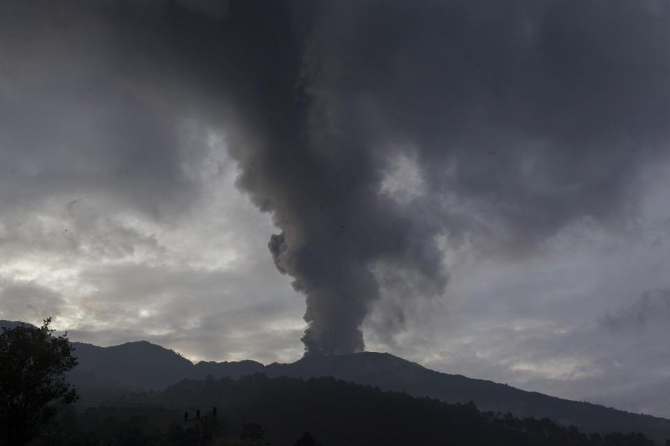 Mount Marapi spews volcanic material from its crater during an eruption in Agam, West Sumatra, Indonesia, Sunday, Jan. 14, 2024. Dozens of people living on the slopes of Mount Marapi have been evacuated from their homes after Indonesian authorities raised the alert level of of the nearly 2,900-meter (9,480-foot) volcano to the second highest as it continues to erupt. (AP Photo/Givo Alputra)