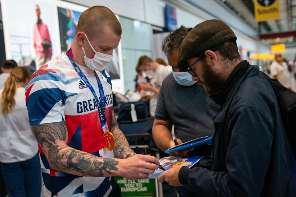 Adam Peaty sign autographs at Heathrow Airport (Aaron Chown/PA) (PA Wire)