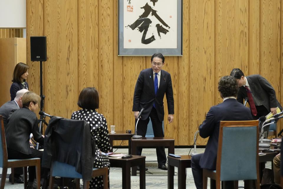 Japan's Prime Minister Fumio Kishida, center, prepares to attend an interview with foreign media members ahead of an official visit to the United States at the Prime Minister's official residence Friday, April 5, 2024, in Tokyo. (AP Photo/Eugene Hoshiko)