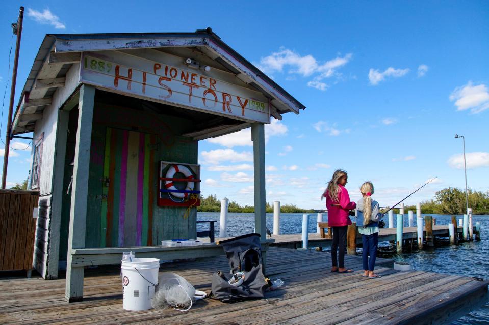 Leah Groff (left), 9, and her sister Joy Groff, 6, both of Sebastian, try their luck at fishing off Jones Pier, Monday, Jan. 29, 2024, in Indian River County. Because of the brisk, windy weather beachside, where they sometimes go with the rest of their family, the girls, sporting warm sweaters, fished on the historic pier, originally built by Richard Milton in 1907 to aid in transportation for citrus growers between the island and the mainland. It is located off the Historic Jungle Trail, on Orchid Island.